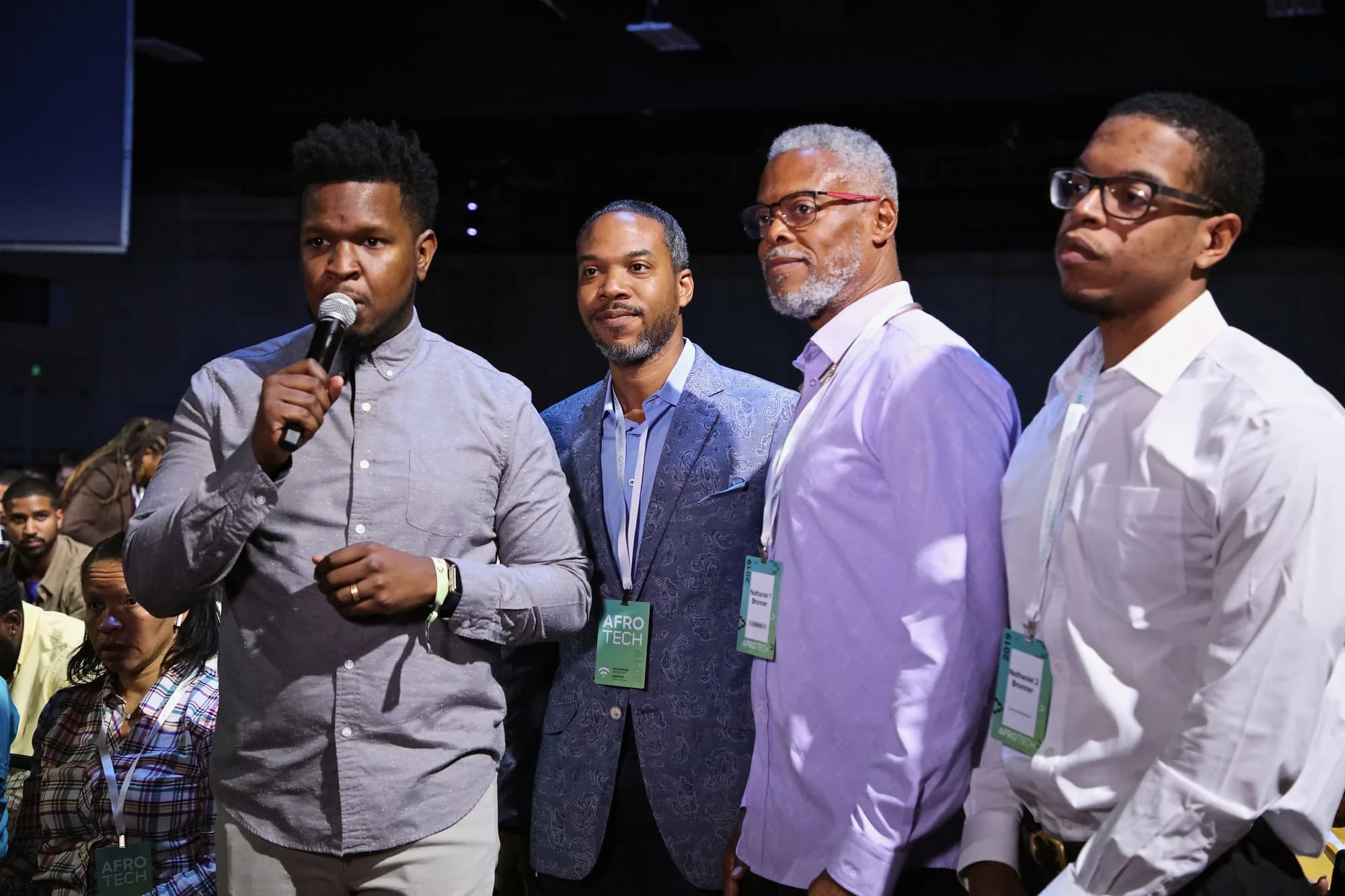 Will Lucas speaking to a live audience from the floor at AfroTech.