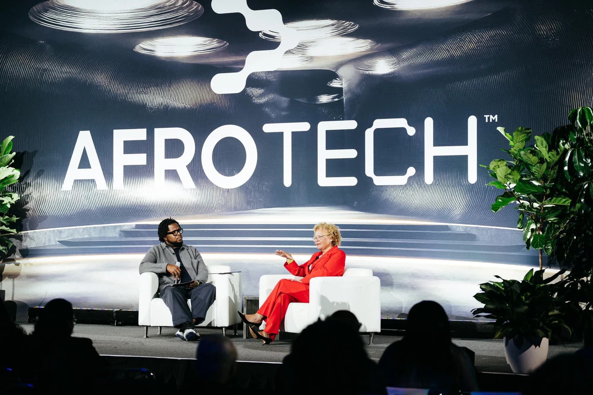 Will Lucas in a one-on-one stage conversation with media executive Debra Lee at AfroTech.